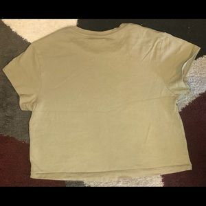 This is a green cropped shirt.
